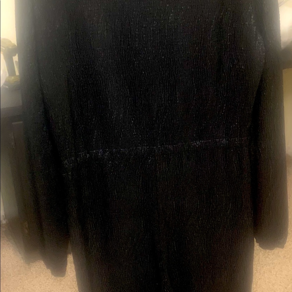 Black woman jumpsuit never worn. Thin material but not see through. Long sleeve